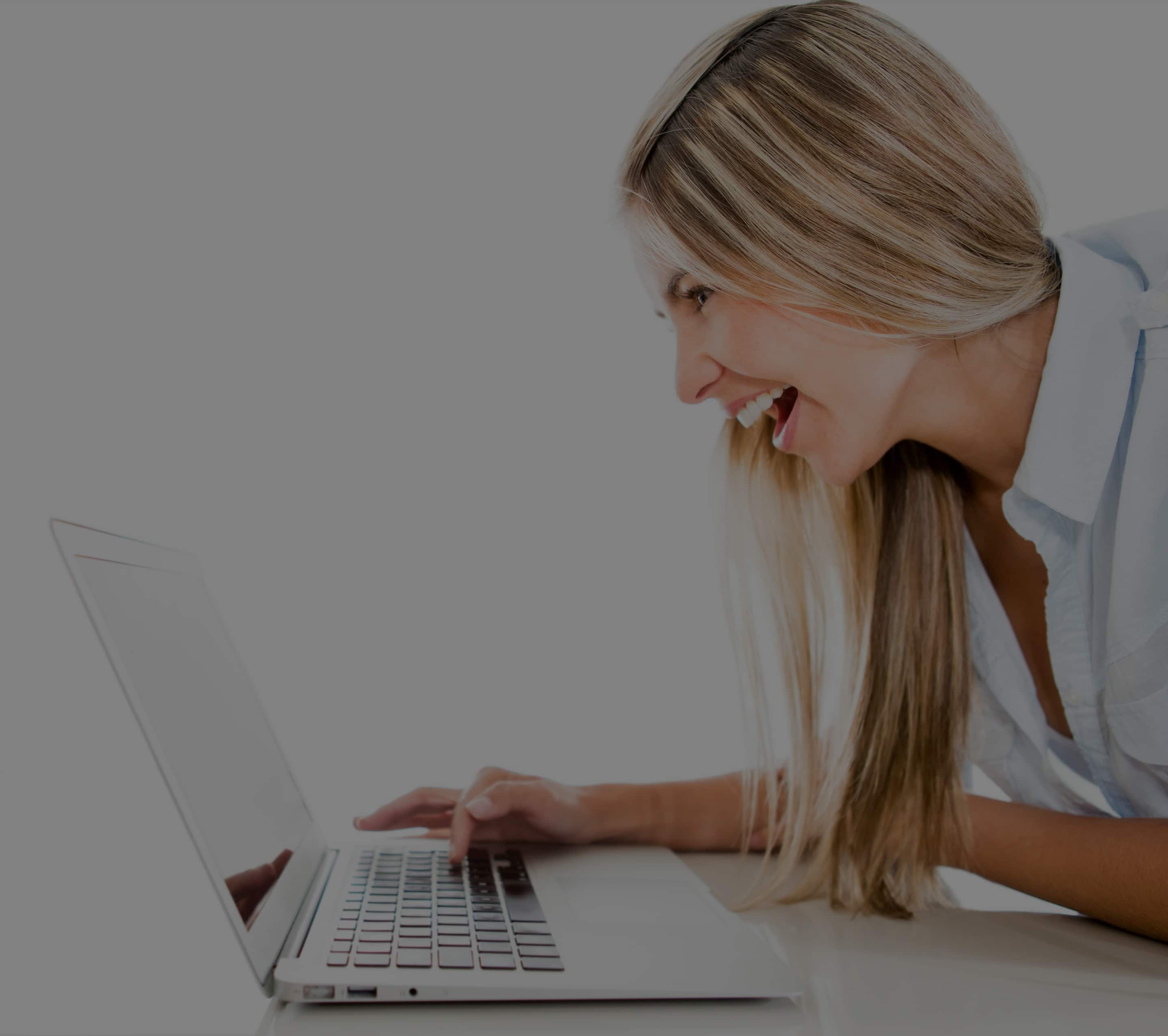 woman smiling at laptop, Dentons Digital, Website Design Build, Wiltshire, Somerset
